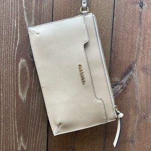 Calvin Klein wristlet; cream with gold logo